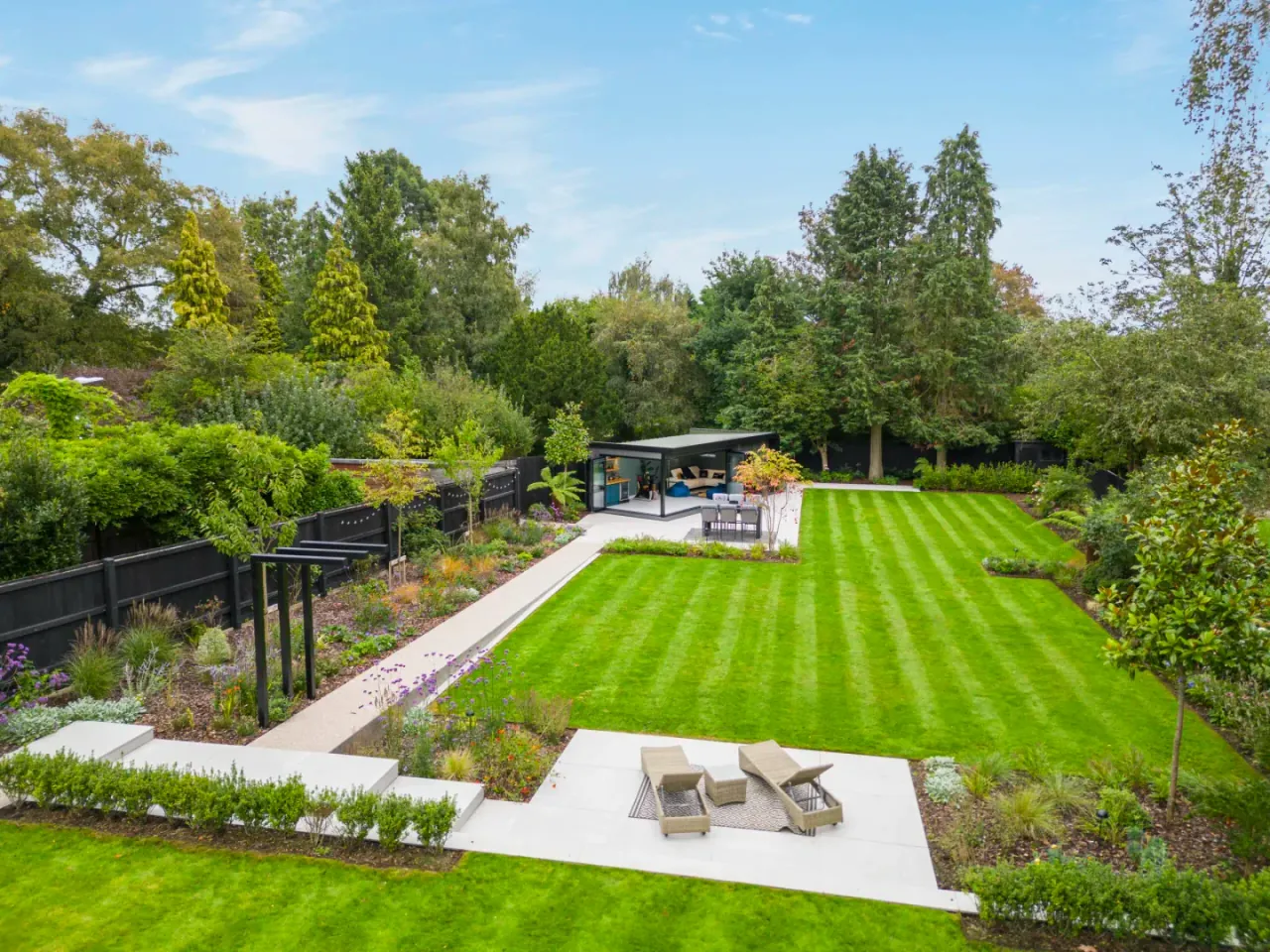 Freshly striped lawn and planted garden beds on a landscaped residential property in Ottawa